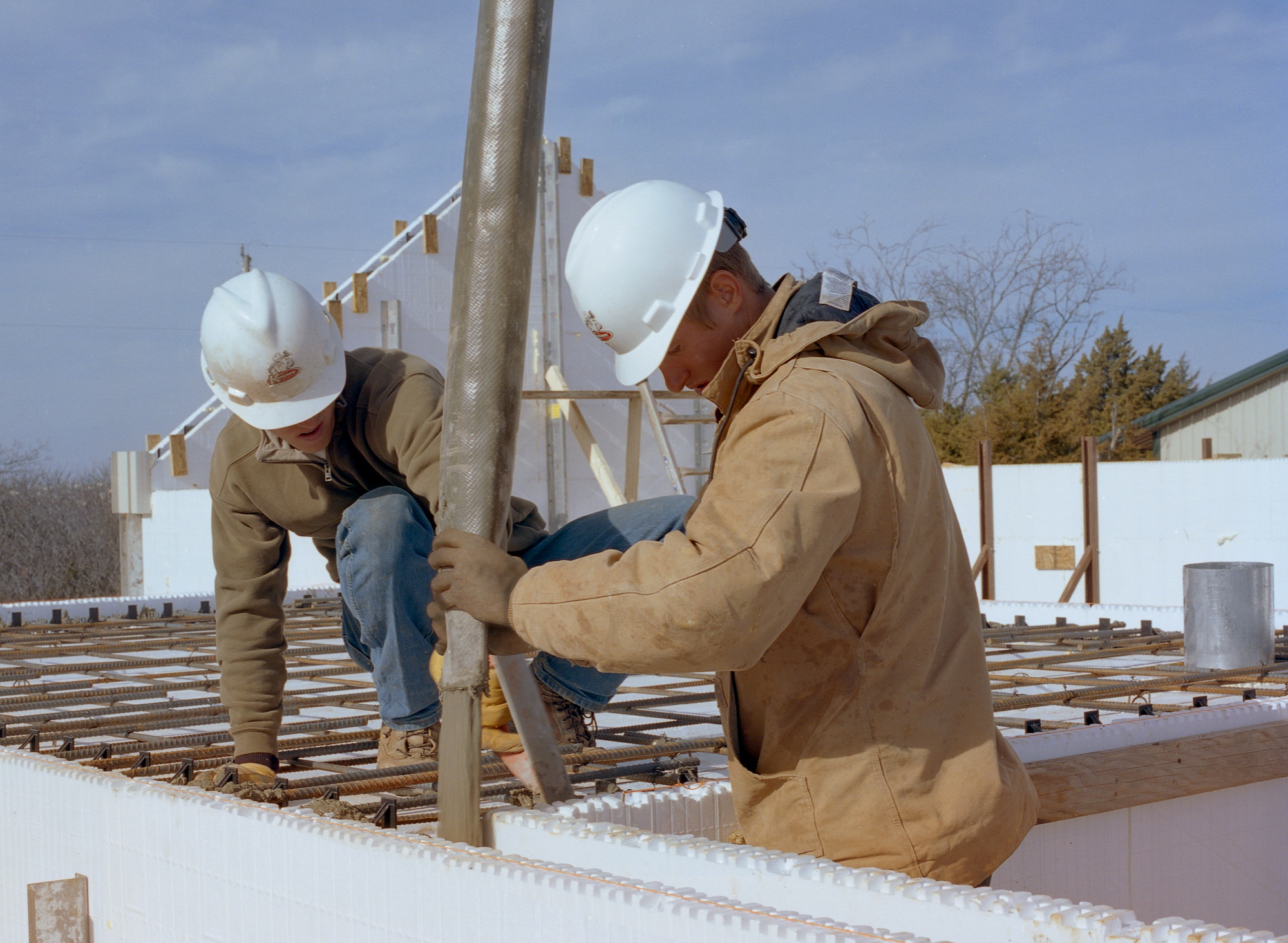 ICF installers pouring concrete